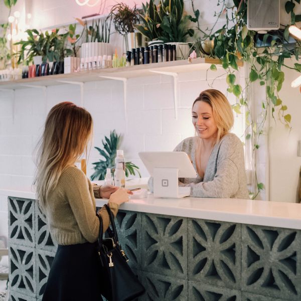 woman purchasing at the counter in shop