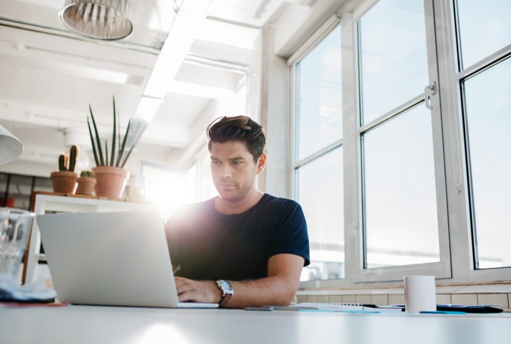 person preparing end of year financials on laptop